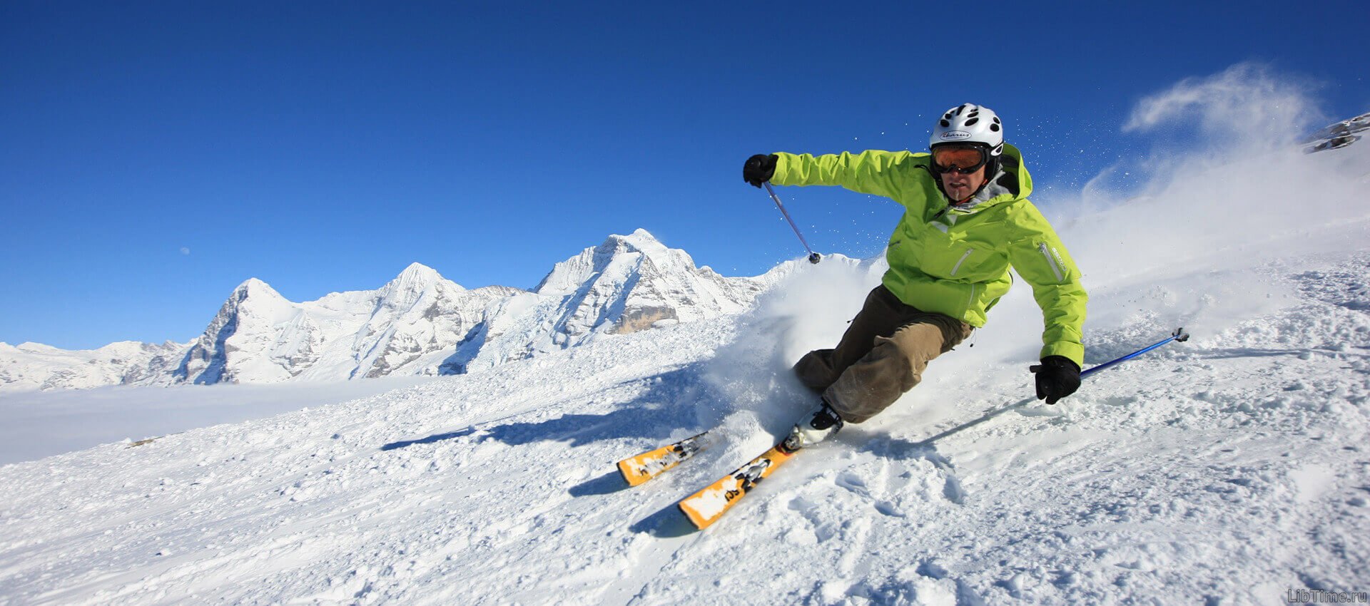 Skier riding through snowy mountain terrain